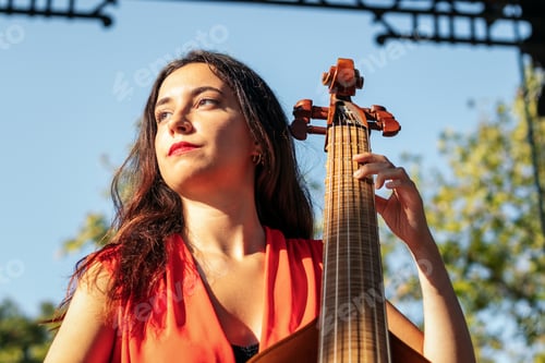 Preview: Woman musician playing cello outdoors