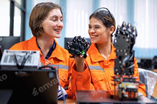Preview: Girl engineer in robot industry fabrication research room simulate testing robot arm on operation