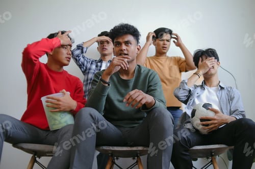 Preview: Focused Group Of Football Supporter Disappointed Watch Favorite Soccer Team Loose The Competition