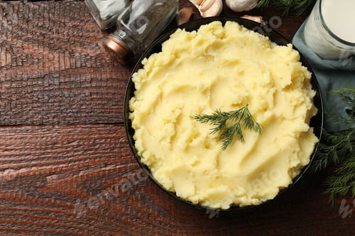 Preview: Delicious mashed potato with dill served on wooden table, flat lay. Space for text
