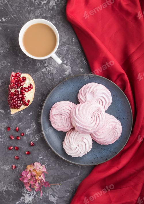 Preview: Pink pomegranate homemade zephyr or marshmallow with cup of coffee on a black concrete