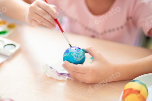Preview: The girl painted the eggs for Easter. Easter eggs watercolor painting. Children's leisure