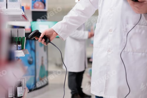 Preview: Pharmacist scanning pharmaceutical products with store scanner while verifies the prescription