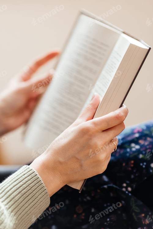 Preview: female hands holding a book to read