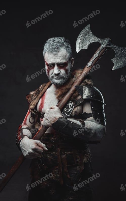 Preview: Serious fighter with naked torso armed with axe in studio