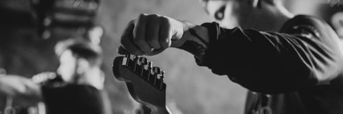 Preview: Man on the stage tuning his guitar
