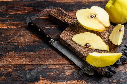 Preview: Fresh gold quince fruits on a cutting board. Dark wooden background. Top view. Copy space
