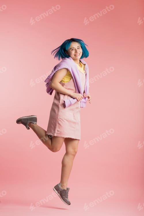 Preview: Fashion cheerful girl moving on a pink background