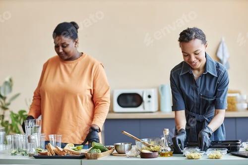 Preview: Two smiling African American women cooking together