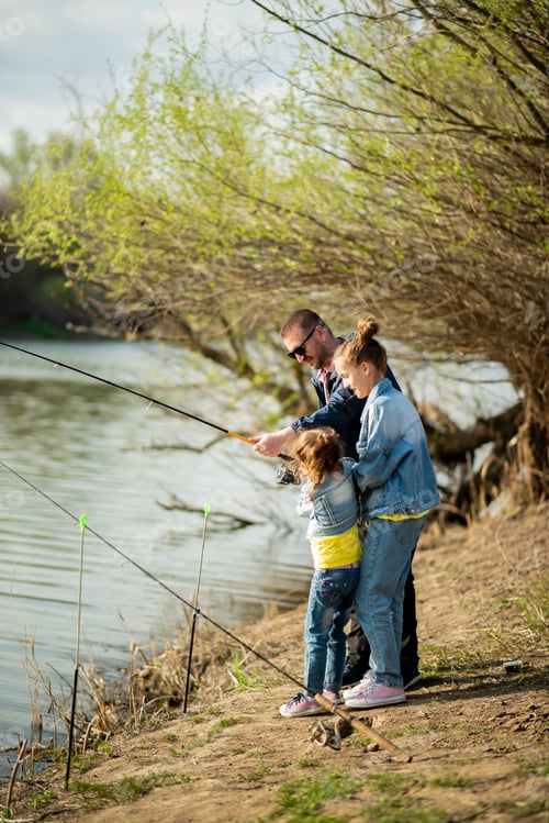Preview: A dad and his two daughters are fishing in the river.