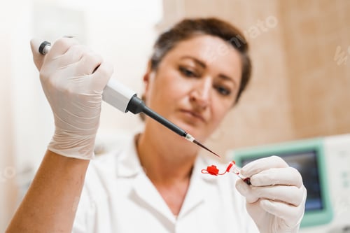 Preview: Blood test performed by lab assistant using dispenser and hematology tools in laboratory