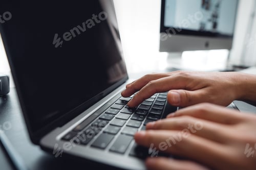 Preview: hands working on a laptop computer