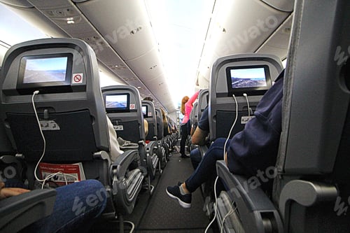 Preview: Using technology. Tech. Airplane. Aeroplane. Watching movies. Watching movie on flight. Traveling.