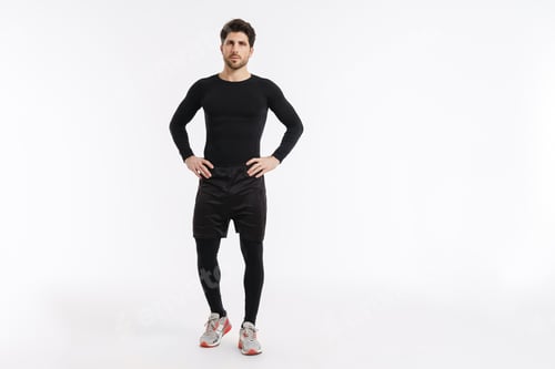 Preview: Young athletic sportsman posing and looking at camera