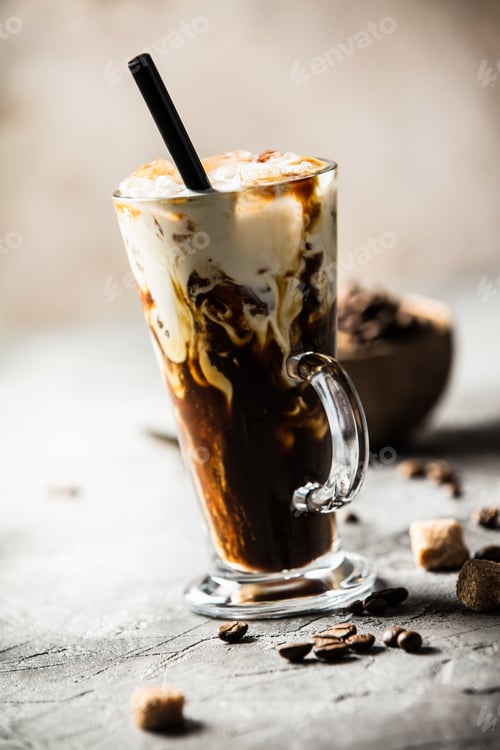 Preview: Iced coffee in a tall glass with cream poured over