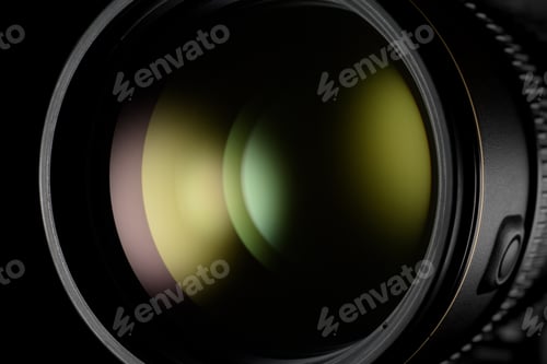 Preview: Photo or video camera lens with green reflection close-up on the black.