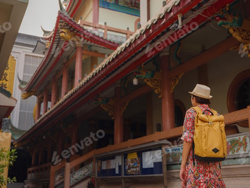 Preview: Woman Exploring Colorful Streets Near Buddhist Temples in Bangkok