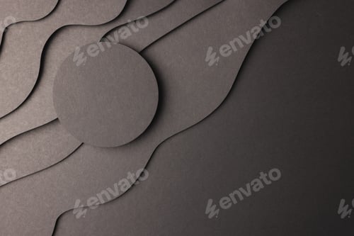 Preview: Circle of black paper with copy space on black waves of paper on black background