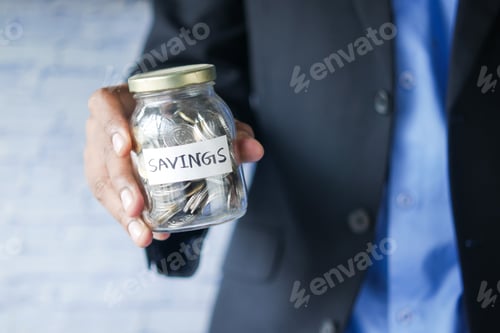 Preview: Savings Jar Held by Man in Business Attire