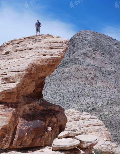Preview: Young man proud to be at top of the stone cliff mountain
