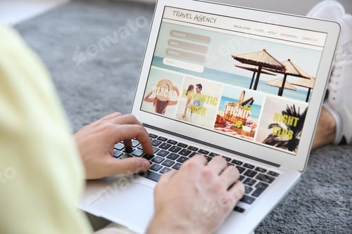 Preview: Man booking tickets online indoors, closeup. Travel agency concept