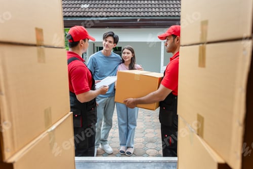 Preview: Caucasian delivery man worker delivering package to young couple in house.