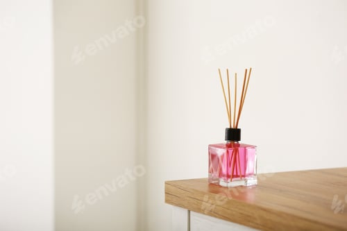 Preview: Aromatic reed air freshener on table against blurred background