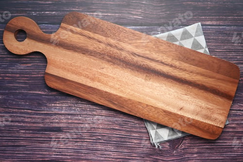 Preview: Top view of wooden chopping board and kitchen towel on wooden background .