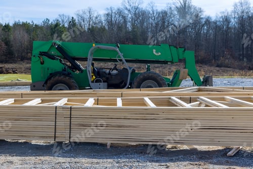 Preview: Boom truck forklift in the new home with wood building frame on new residential construction framing