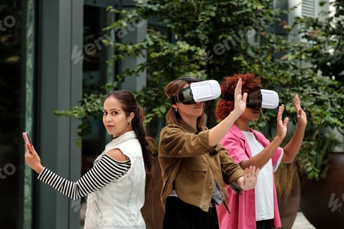 Preview: Three young women experiencing virtual reality with headset