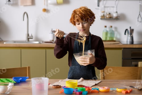 Preview: Creative kid blends happiness while baking delicious treats in a cozy kitchen