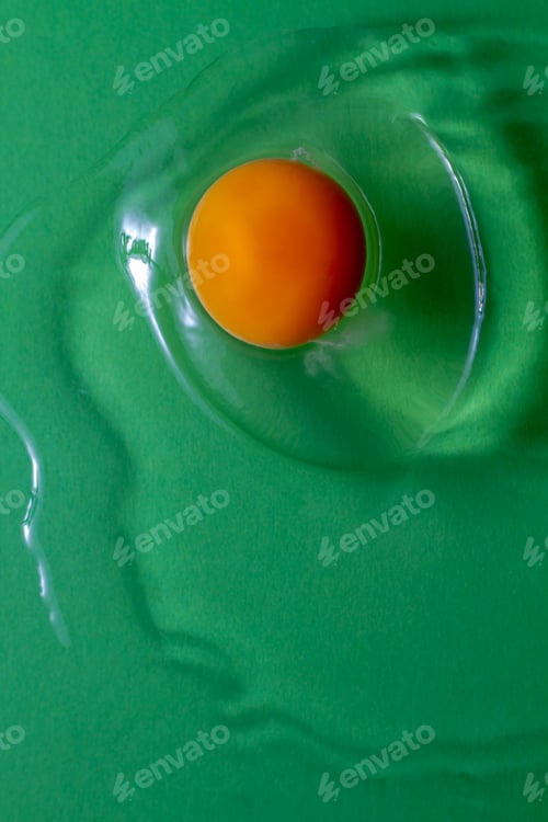 Preview: Raw egg on green background