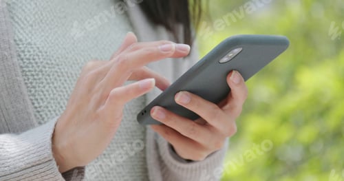 Preview: Close up of use of mobile phone at city park