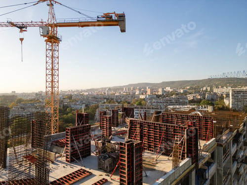 Preview: A drone video capturing the construction site of a high-rise building at sunset. The structure's