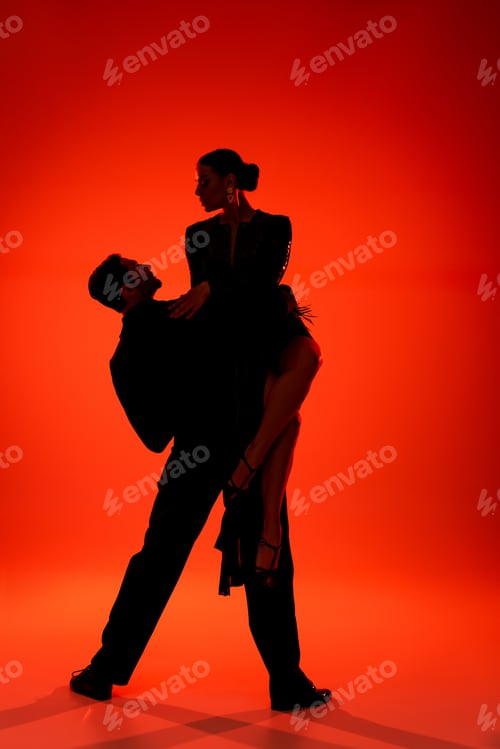Preview: Silhouette of professional couple of dancers performing tango on red background
