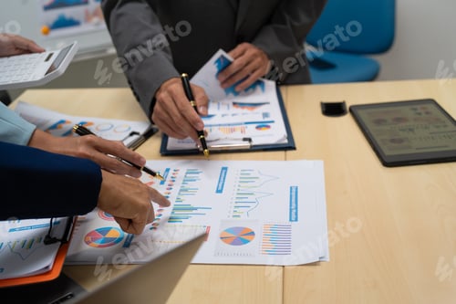 Preview: A businessperson, holding hands, cooperate during a corporate meeting. review a graph document