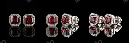 Preview: beautiful garnet earrings with diamonds in a gold chain on a black background