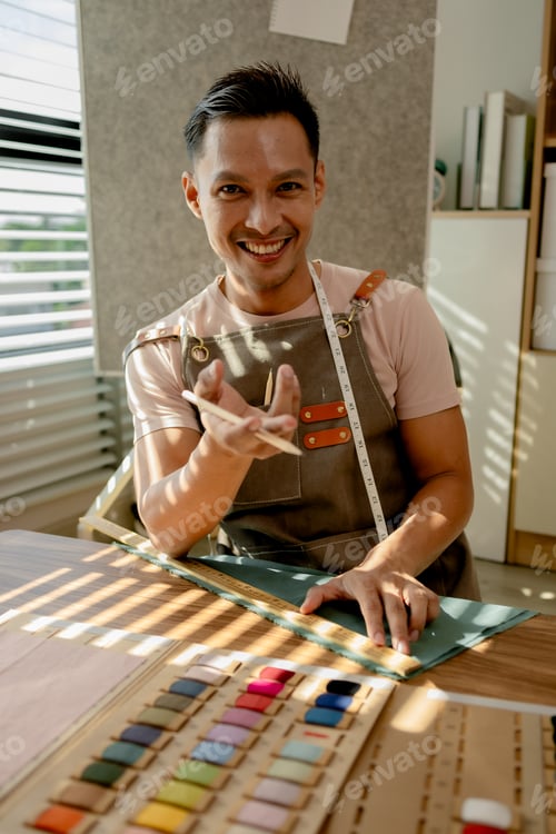 Preview: a fashion designer is working in his studio doing what he loves, he does many things such as using a