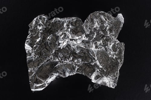 Preview: top view of glossy crumpled silver foil isolated on black