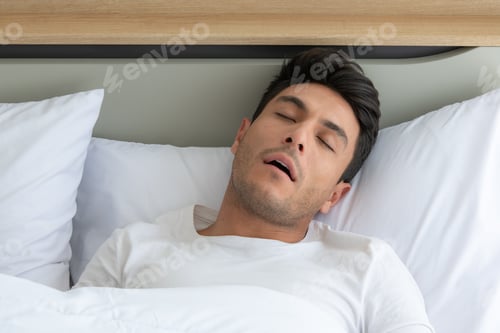 Preview: Man was sleep and snore in the white bedroom of the apartment
