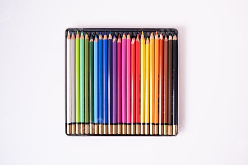 Preview: Colored pencils in a box on a white background. Flat lay, top view. High quality photo