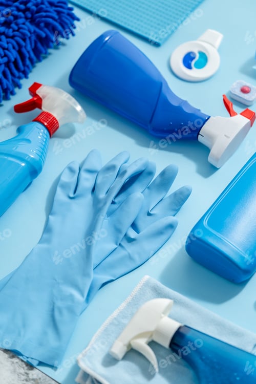 Preview: Colorful cleaning products on plain blue background. Housecleaning concept