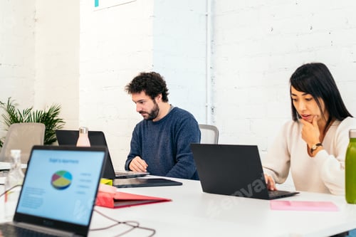 Preview: Group of multiracial people working with laptop in a coworking