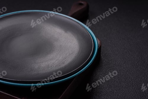 Preview: Empty ceramic round plate on dark textured concrete background