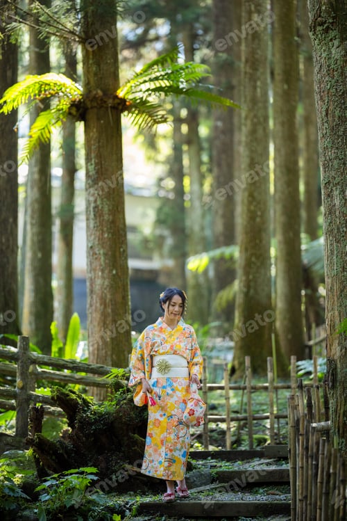 Preview: Asian woman try to wear Japanese kimono walk in the forest