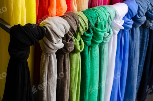 Preview: Colorful hanging shawls or scarves on the street market. Pattern or background concept