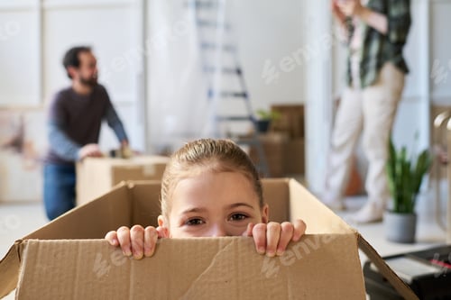 Preview: Cute child having fun in cardboard box