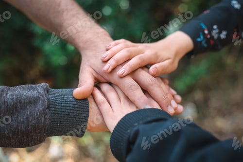 Preview: Closeup of the hands of people on each other under the sunlight at daytime