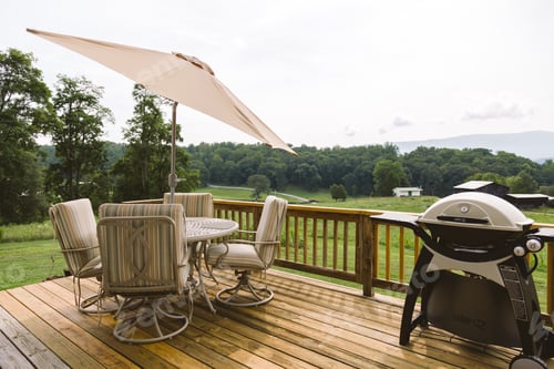 Preview: Backyard deck with grill and picnic table.