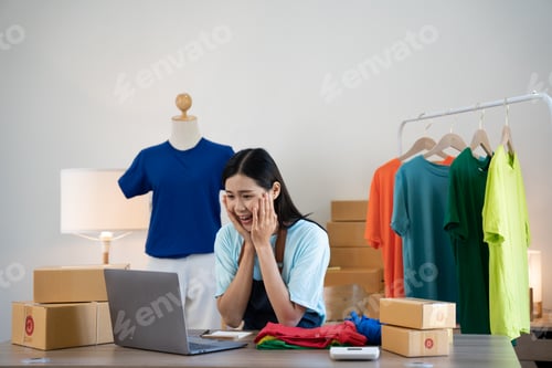 Preview: Female startup small business owner working with notebook computer at office. Online selling. E-comm